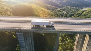 trucks-on-highway-in-mountain-at-sunset-1